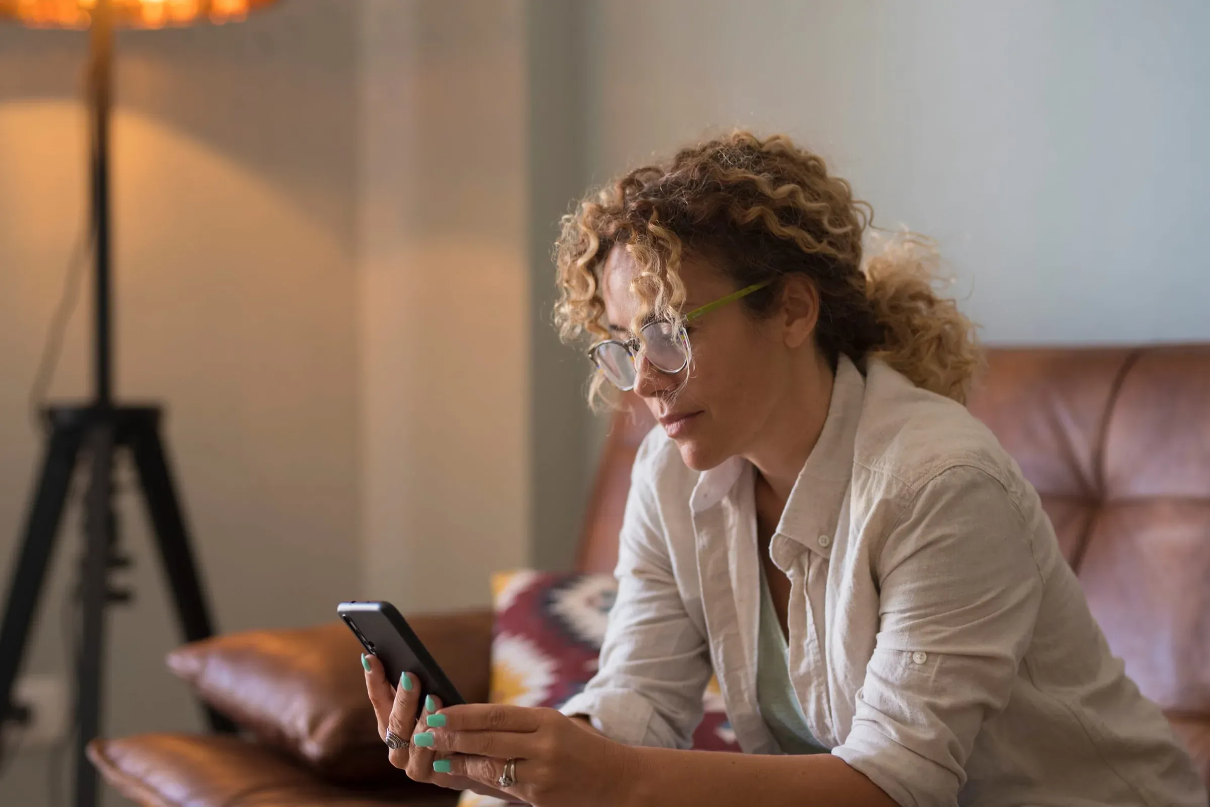 A woman on a sofa engaged with her phone